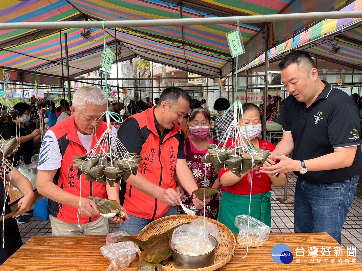 魚池農會理事長劉啟行、總幹事王威文、常務理事陳炳韶一起體驗包粽子的樂趣。