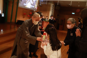 德晗、德濎師父發送福慧紅包給信眾，祝福大眾平安。（記者扶小萍攝）