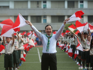 市長朱立倫出席慶祝大會，與新泰國中的童軍們揮動雙旗操弘揚童軍精神。（圖／記者黃村杉攝）