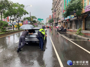 男子駕車路中拋錨，平警冒雨伸援推車解危