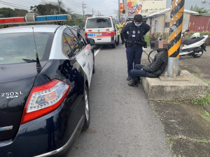 老翁騎著腳踏車出門沒找到朋友，虛弱的靠在路邊電線桿旁，員警獲報到場關心